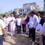 Col. Rajyavardhan Rathore inspecting an underground utility trench and reviewing smart road development work with on-site engineers.