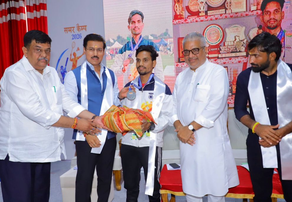 Sports Minister Col. Rajyavardhan Rathore inspiring young village runners and interacting with international coaches during the opening of the 2026 summer camp.