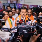 First-time young entrepreneurs showcasing an innovative tech product prototype to Cabinet Minister Col. Rajyavardhan Singh Rathore at a Jaipur startup meet.