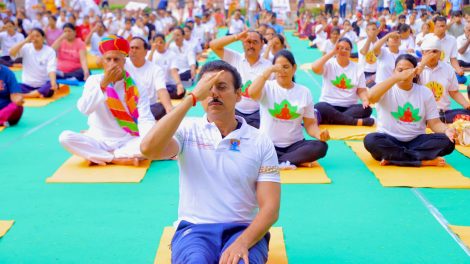 Rajasthan Youth Minister Col. Rajyavardhan Singh Rathore is practicing yoga and speaking on preventative fitness at a public health gathering in Jaipur.